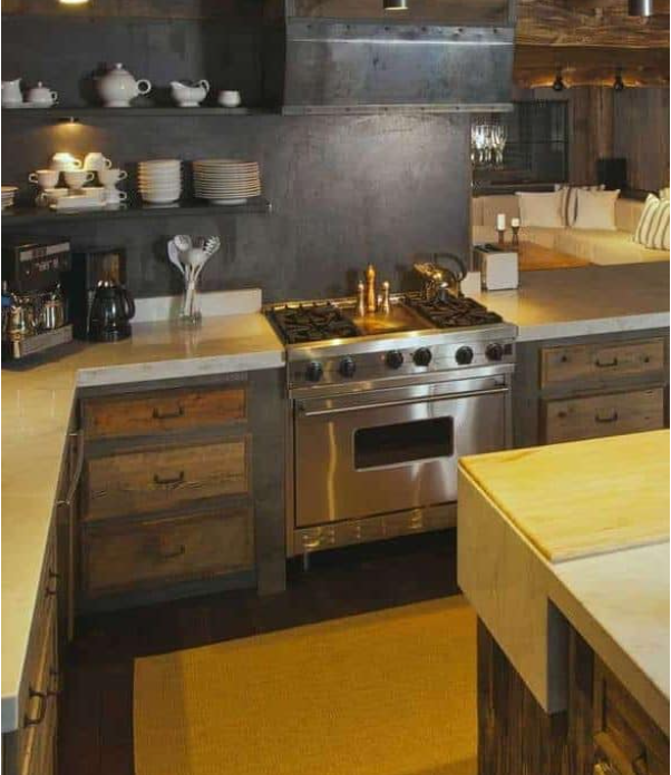 Fully-equipped rustic log cabin kitchen with dark stone walls