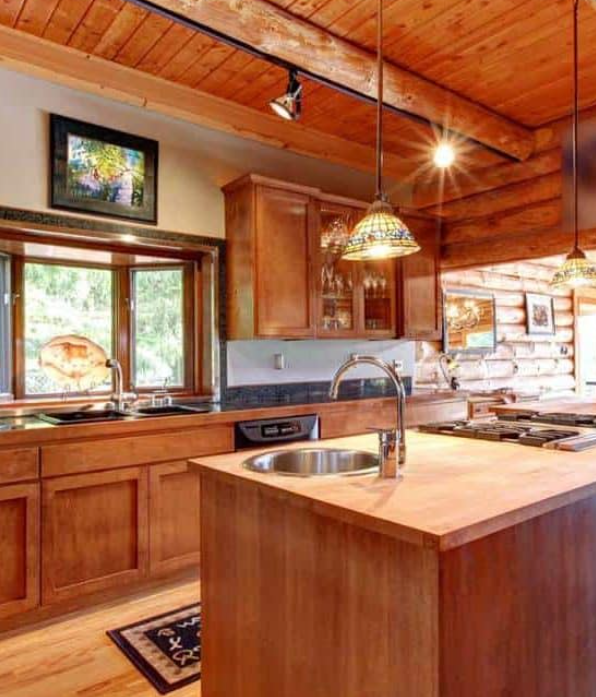 Large kitchen with island in a log cabin