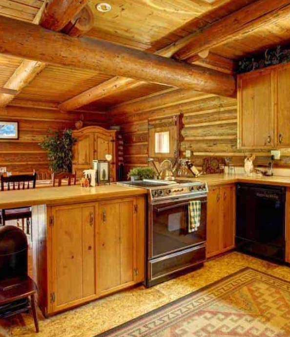 Wood cabin rustic kitchen interior with oak beams and stone flooring