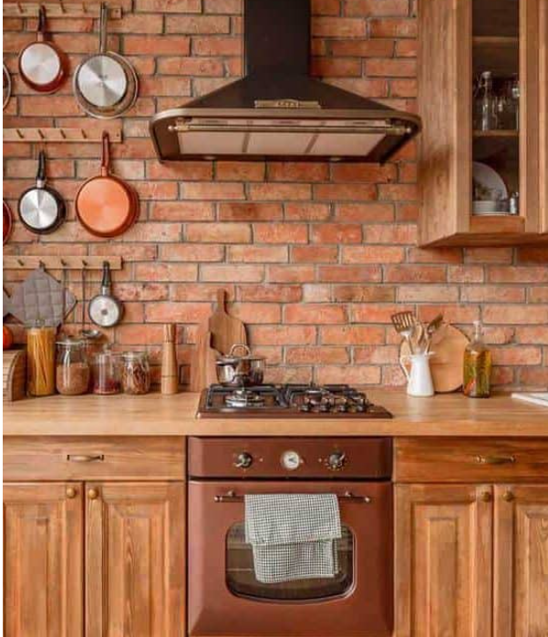 Primitive style kitchen adorned with copper appliances and cooking items